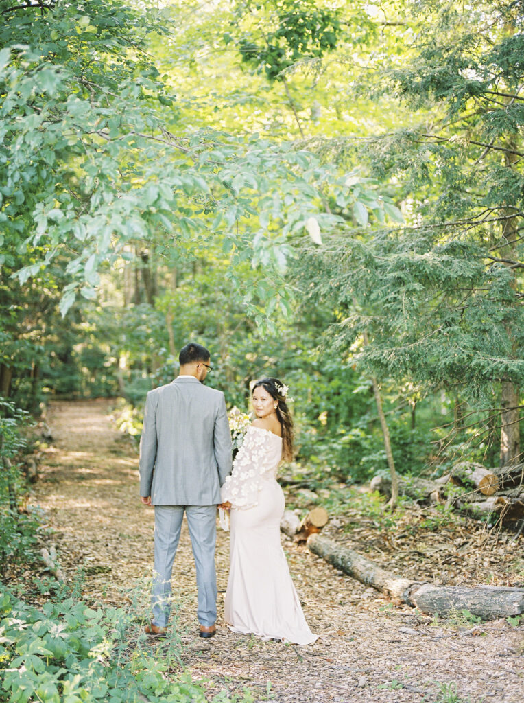 Bride and Groom taking wedding portraits in the woods at the Ashwood Inn in Bayfield, Ontario.