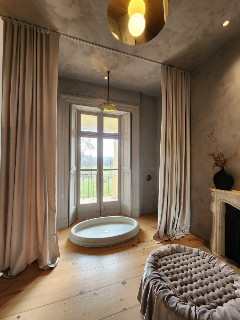 Bathroom at Lune 1860 with rain shower and curtains overlooking the garden